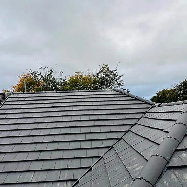 Grey concrete tile re-roof with new ridge tiles