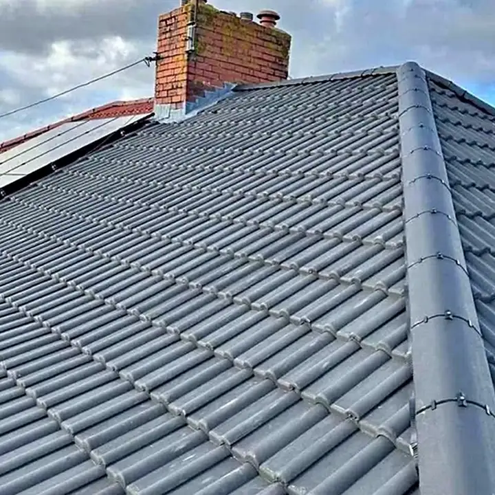 Concrete tile re-roof showing the ridge and chimney