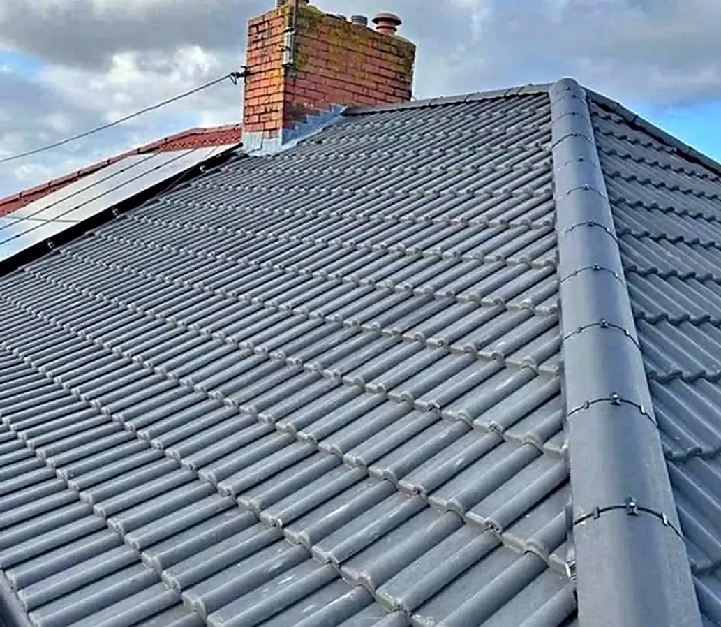 Concrete tile re-roof showing the ridge and chimney